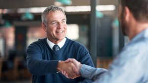 Two men shaking hands in agreement.