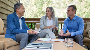 A husband and wife in their late 50s meet with their financial professional to discuss retirement strategies, including asking what is a market value adjustment?