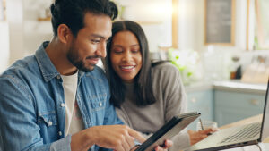 Husband and wife looking at a tablet displaying information about copay dental plans.