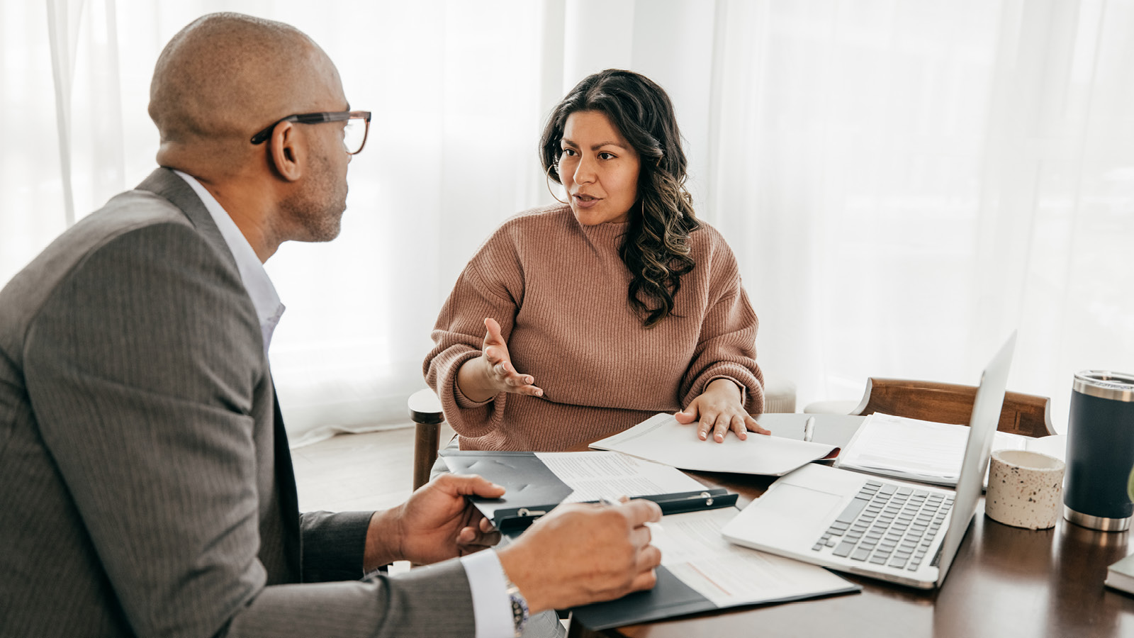 A financial professional and his client discuss the benefits of financial planning to help plan her future.