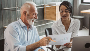 A financial professional meets with his plan sponsor client to share the 2025 cost of living adjustment and discuss the impact of retirement contributions and plan strategy.