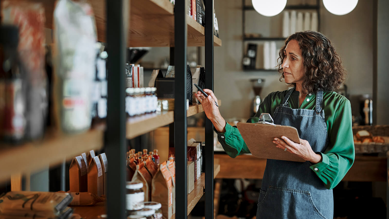 A small business owner reviews the inventory in her store.