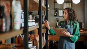 A small business owner reviews the inventory in her store.