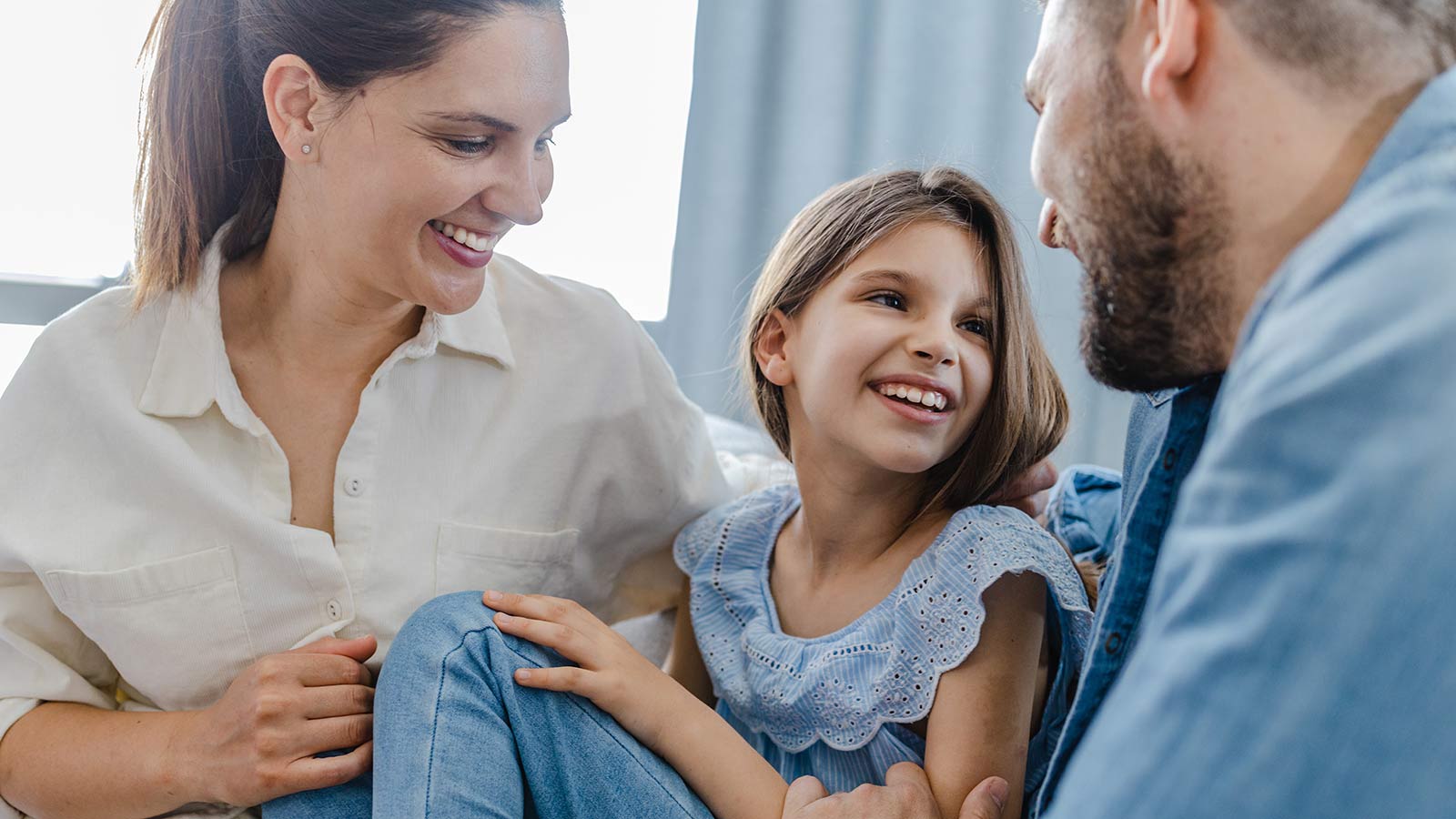 Smiling happy girl with mom and dad