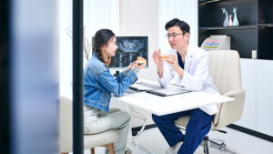 Young woman having x-ray consult with dental specialist.